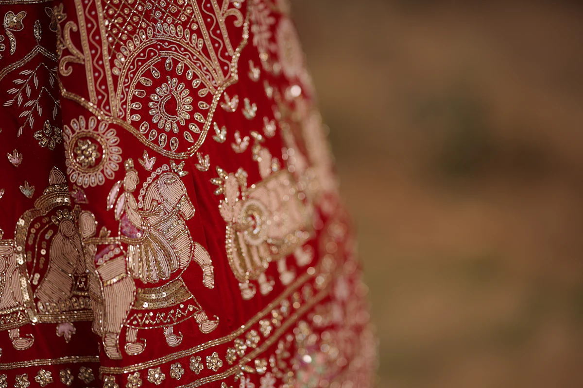 A close up of a red and gold dress — Bride entry formats, ranked by what can go wrong
