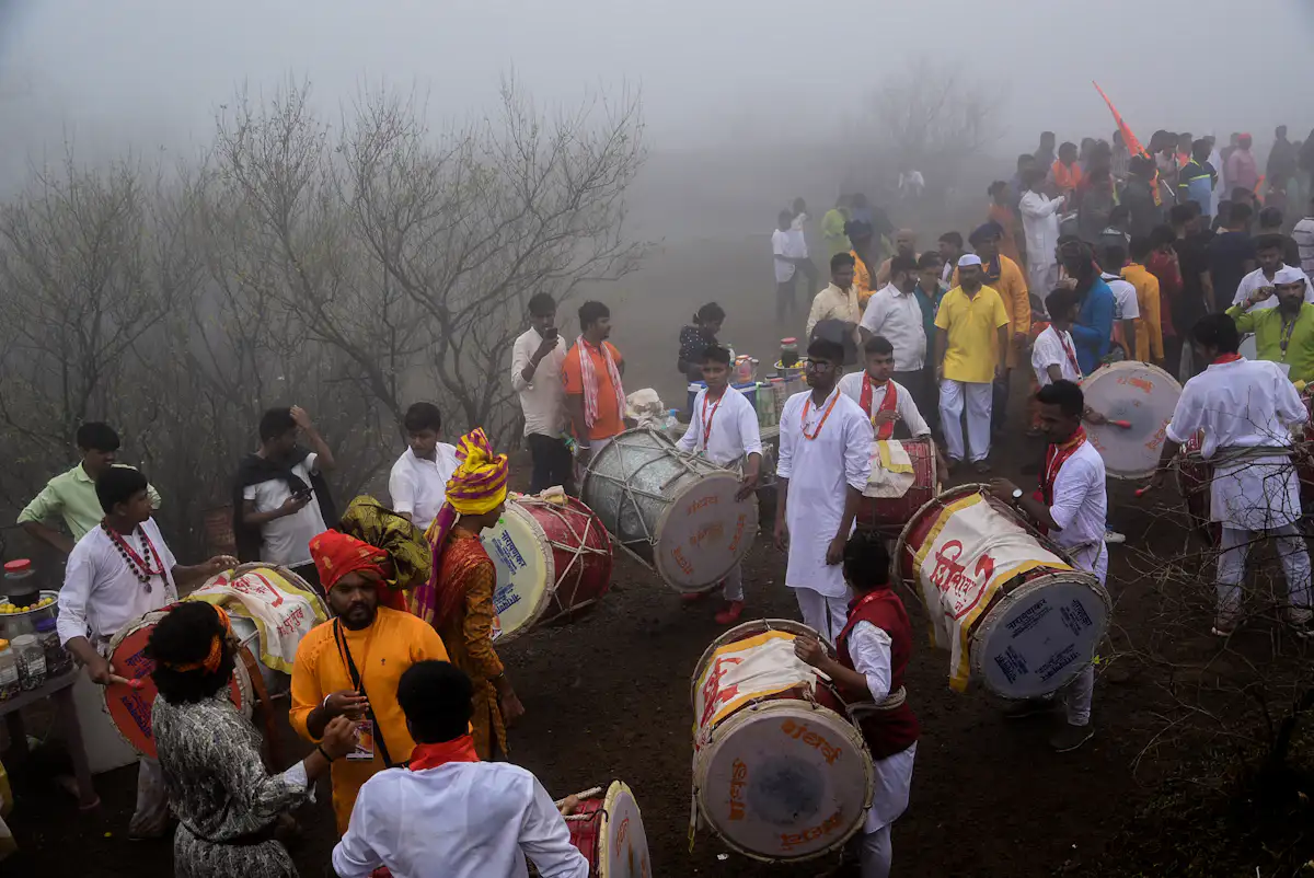 people gathering outside and playing musical drums at daytime — A dhol-tasha pathak