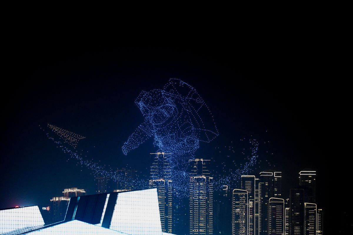 Breathtaking drone light show forming astronaut shape above city skyline, showcasing innovation. — Drone light shows