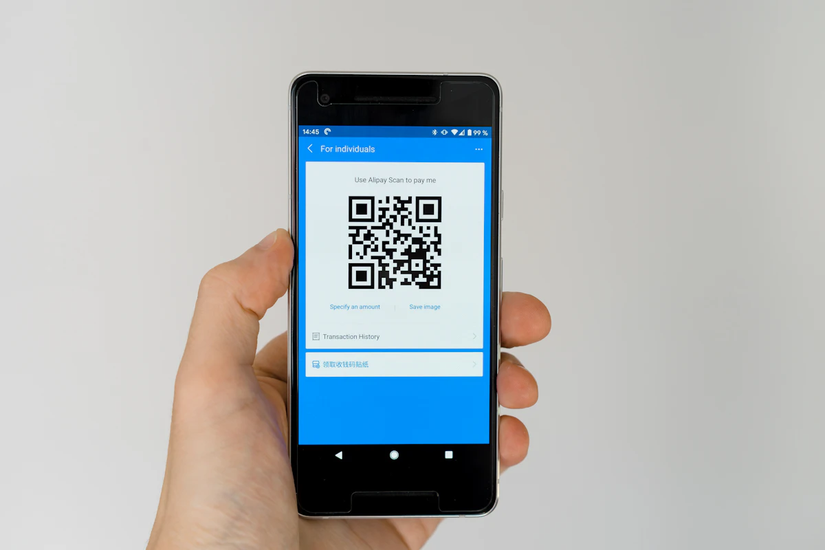 black android smartphone displaying qr code — The entry pass, from the guest’s side