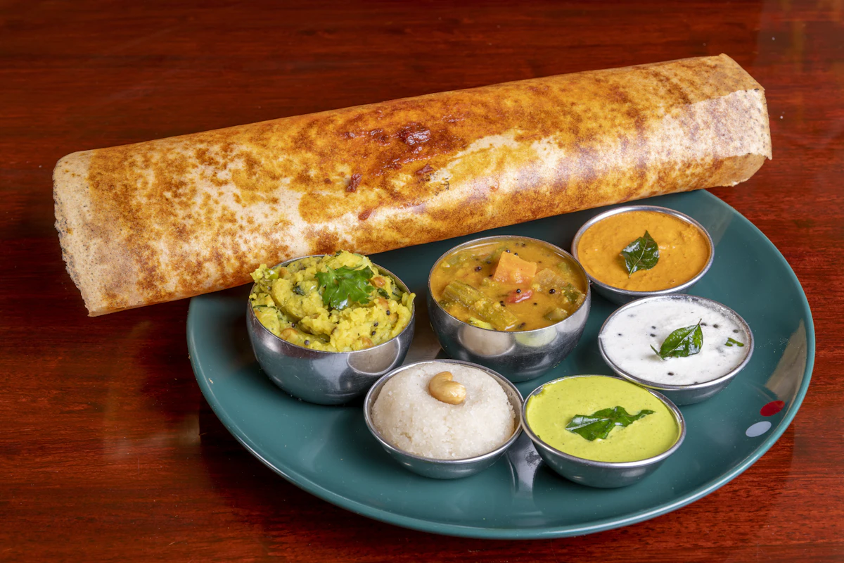 A crispy dosa served with potato masala, sambar, and three types of chutney — The live dosa and appam counter