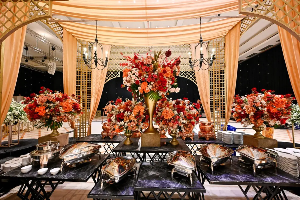 Elegant wedding venue with lavish floral decor and buffet setup in Bandung, Indonesia. — How many plates you are actually paying for