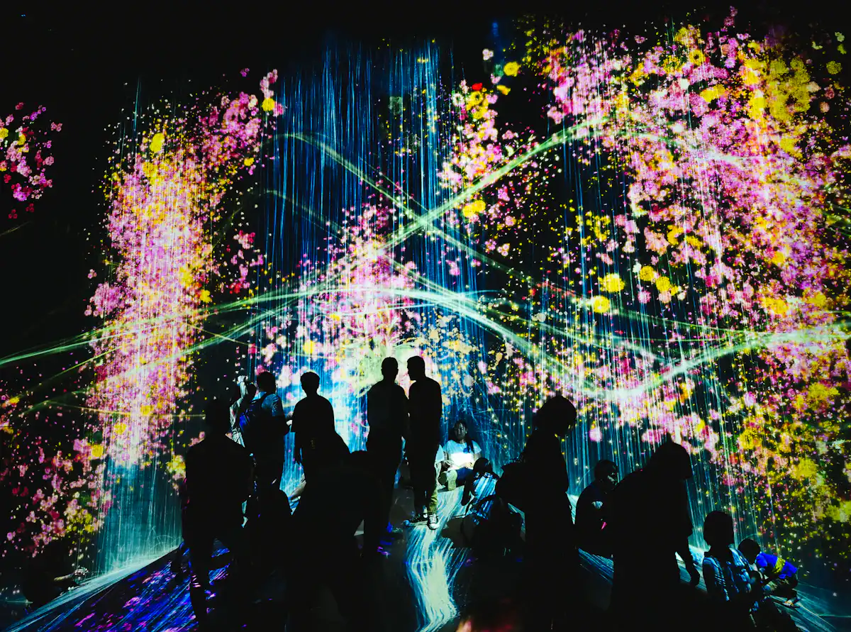 people walking on street with lights turned on during nighttime — Projection mapping on the backdrop