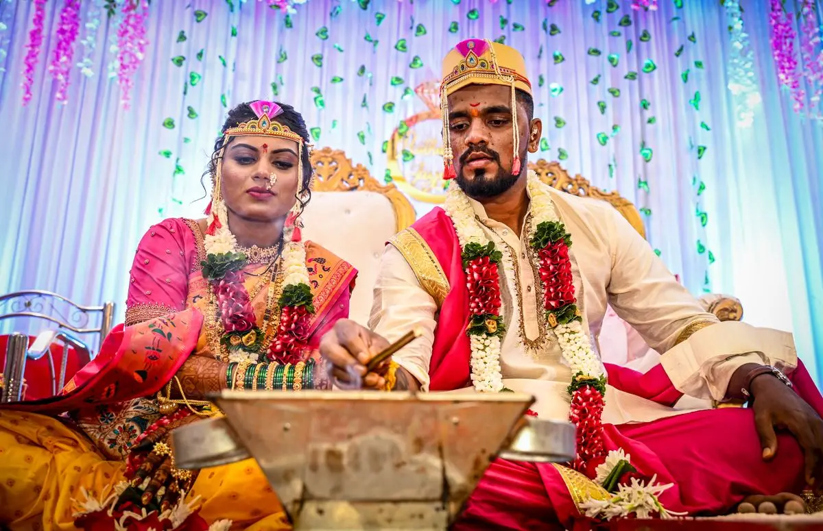 A bride and groom performing traditional Hindu wedding rituals