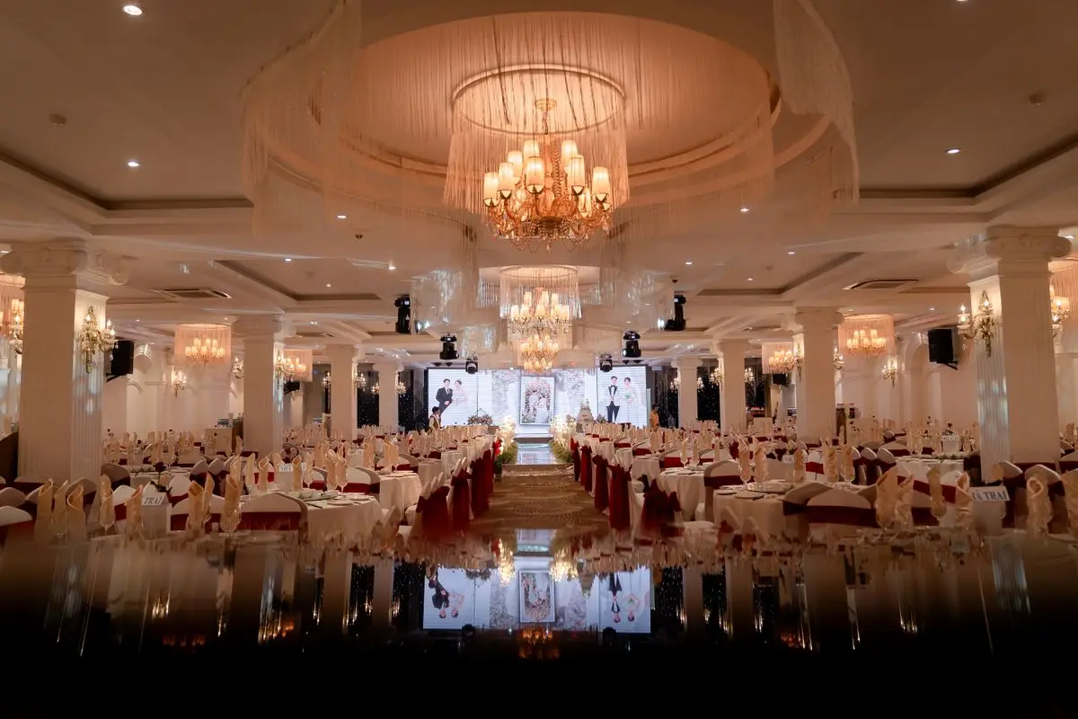 A chandeliered ballroom set for a formal banquet